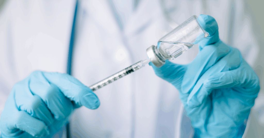 an image of a syringe and a vial, probably for vaccination purposes